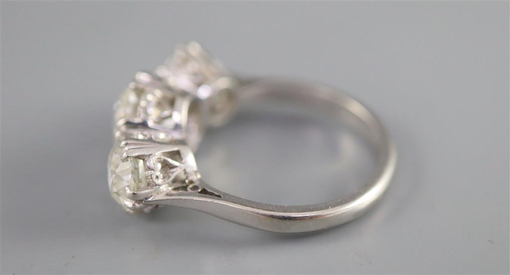 An impressive platinum and three stone diamond ring,